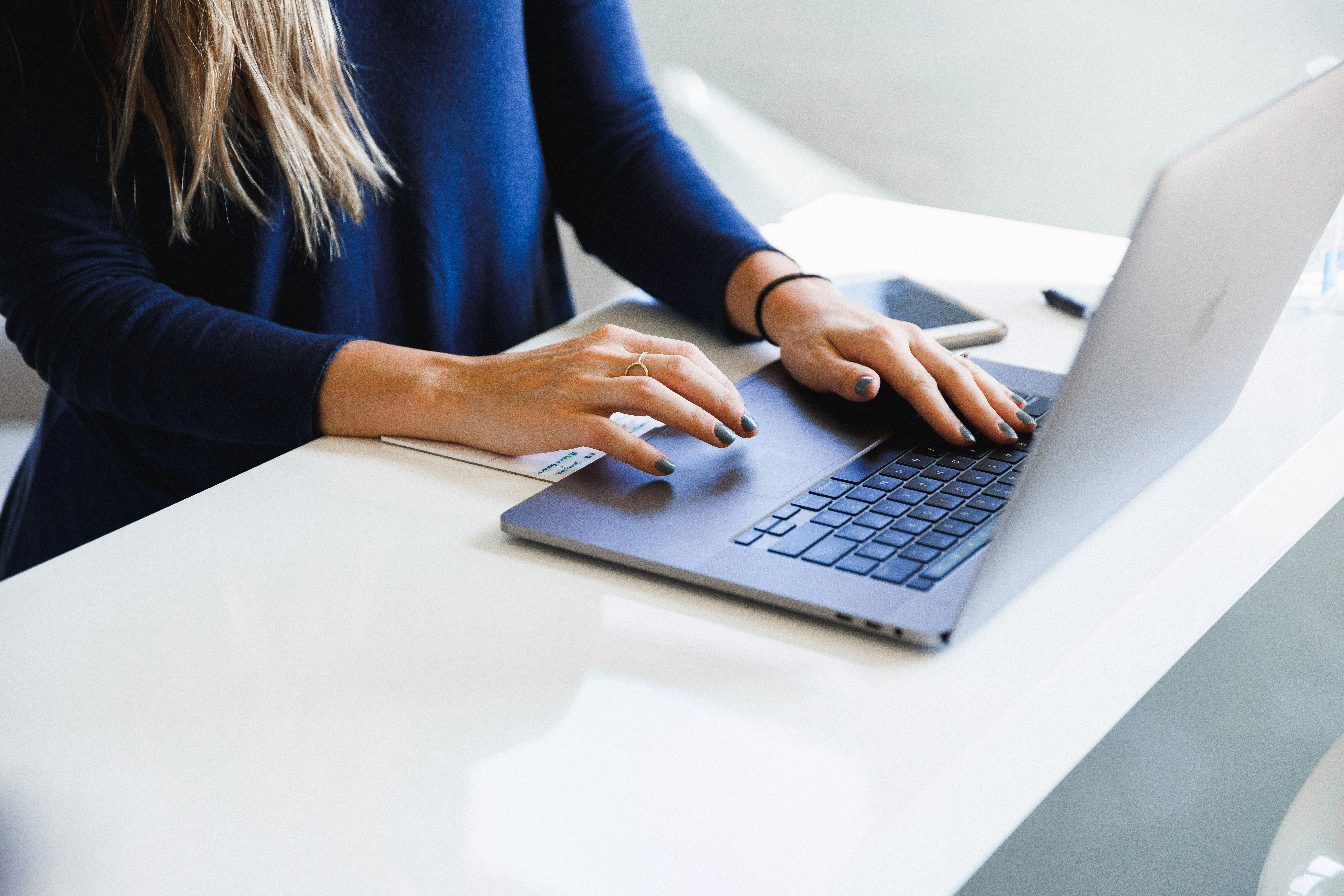 A person typing on a laptop